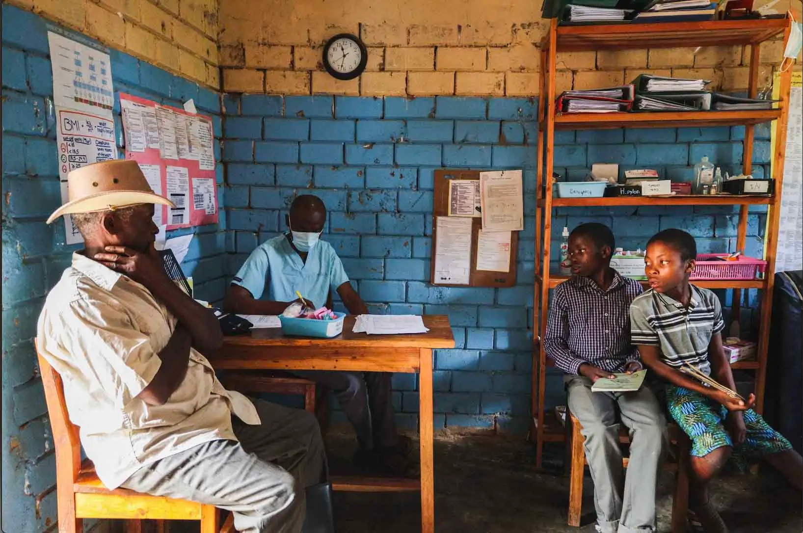 Father and his sons receiving medical care